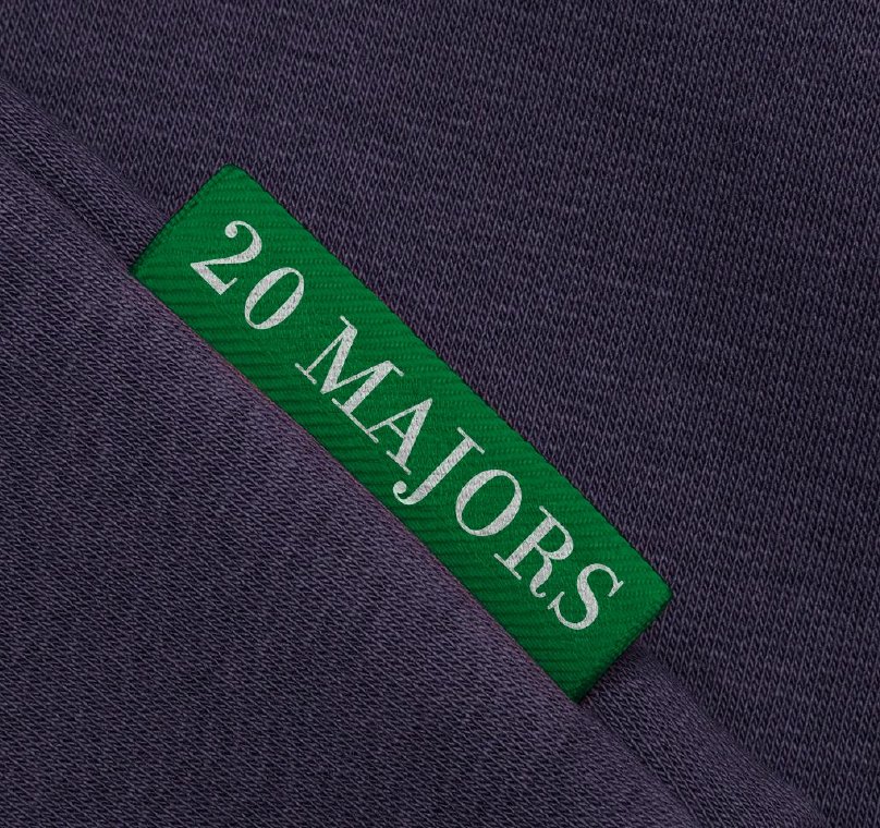A green 20 Majors brand tag set into a navy seam.