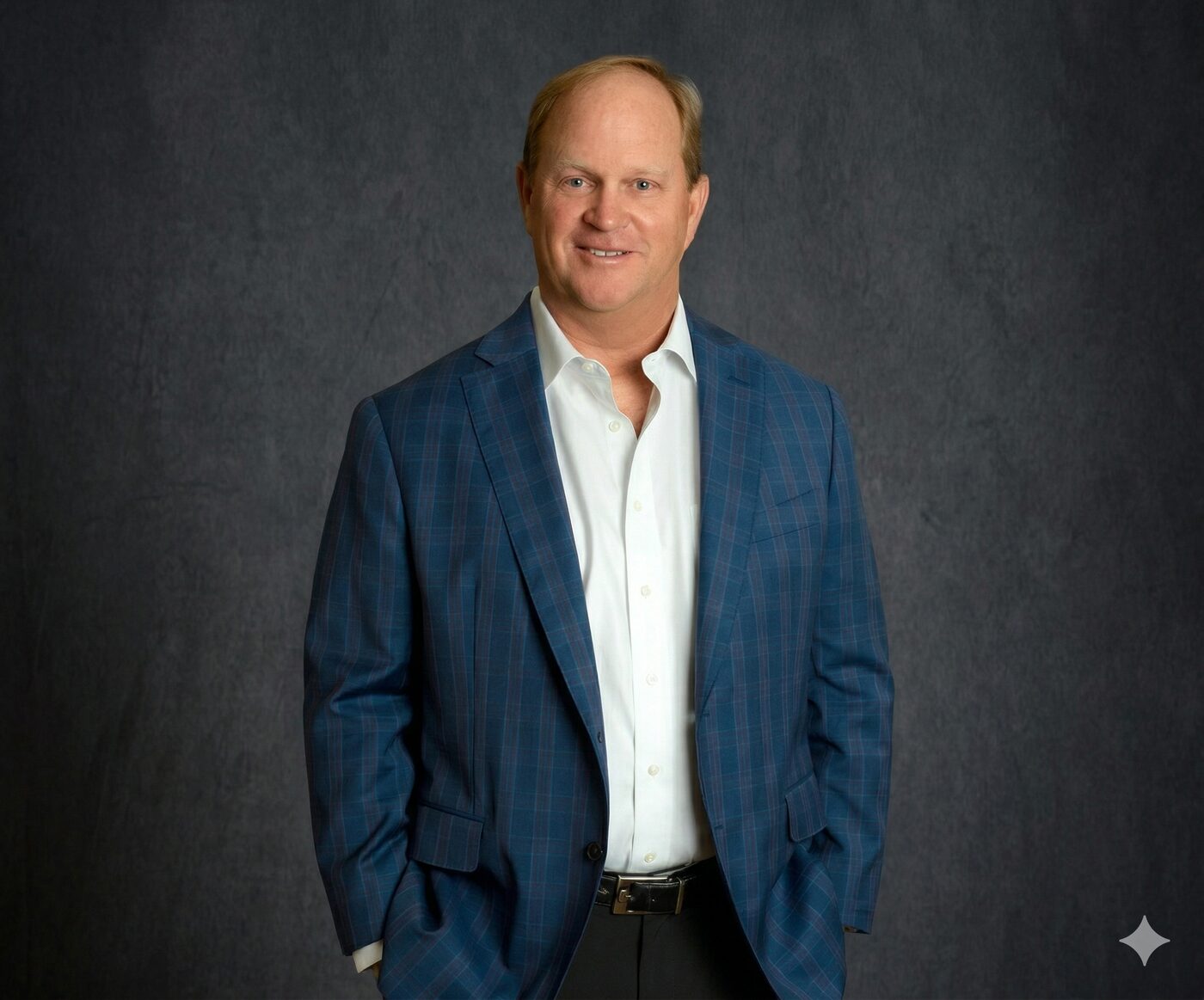 Gary Nicklaus in a navy checked jacket against a dark studio backdrop.